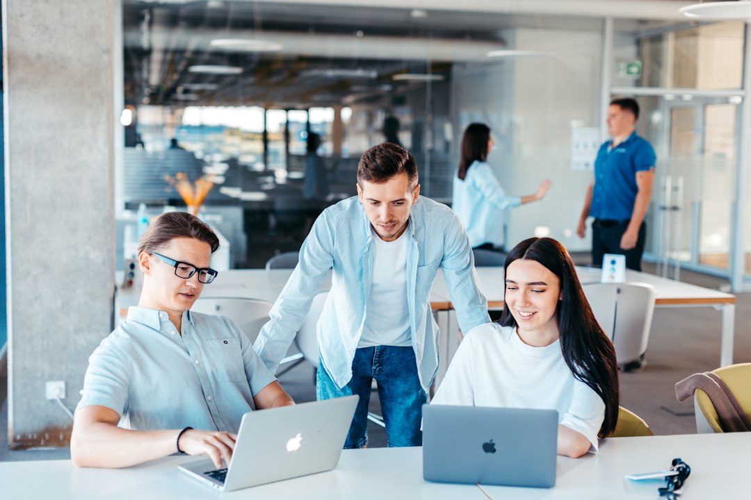 Team working together on laptops in a bright office