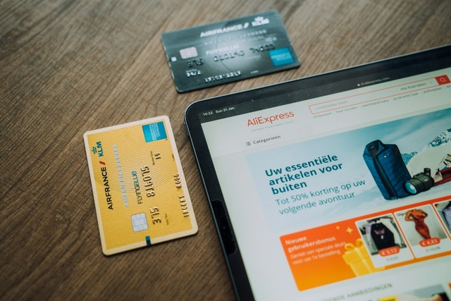 Tablet showing an online store next to payment cards