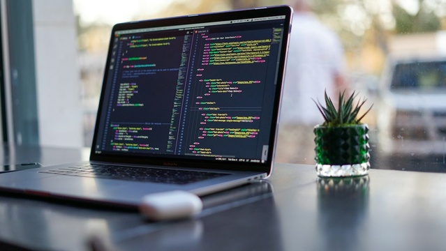 Laptop with code on screen on a desk