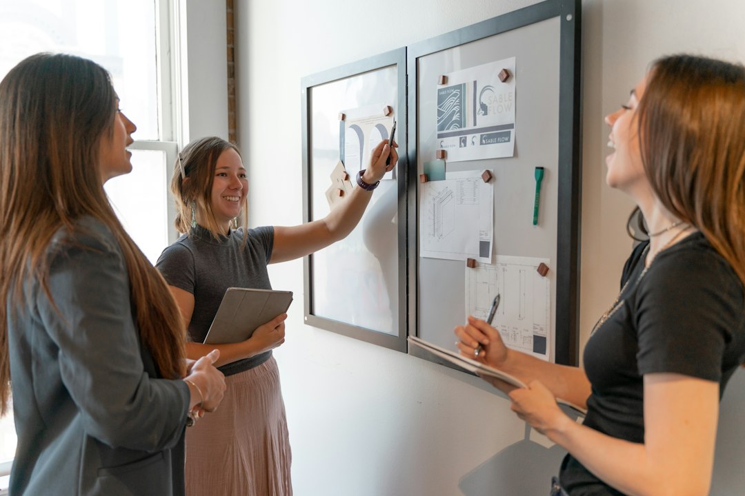 Team reviewing plans on a whiteboard